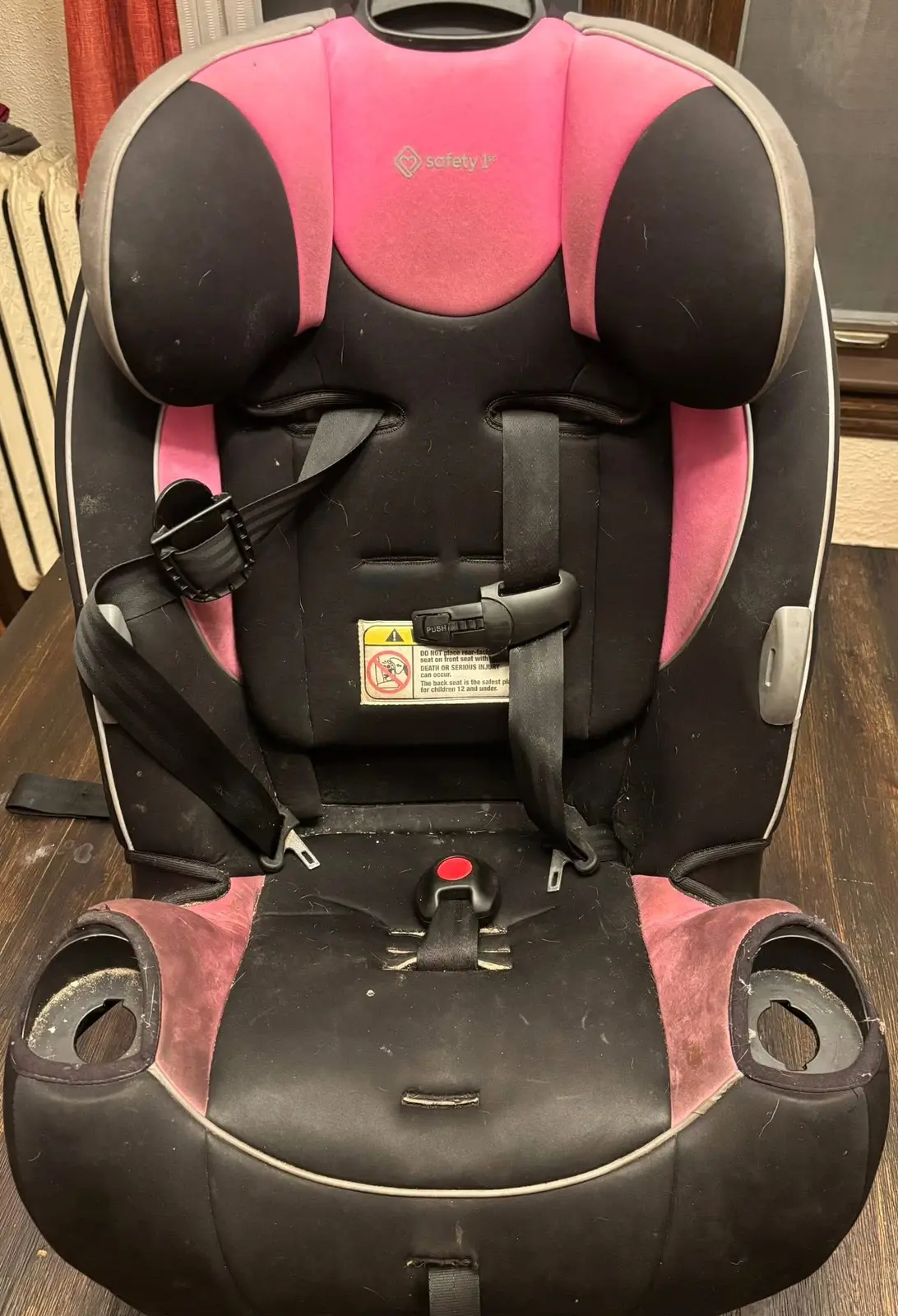 Pink and black car seat before cleaning